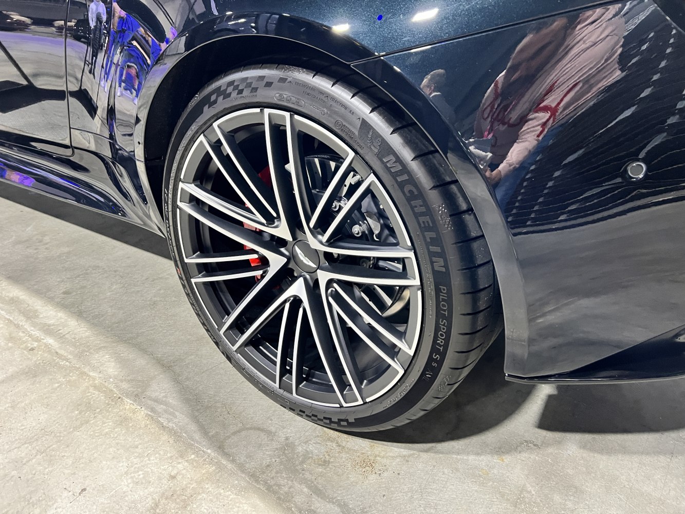 Alloy wheel with Michelin Pilot Sport tire and red brake caliper