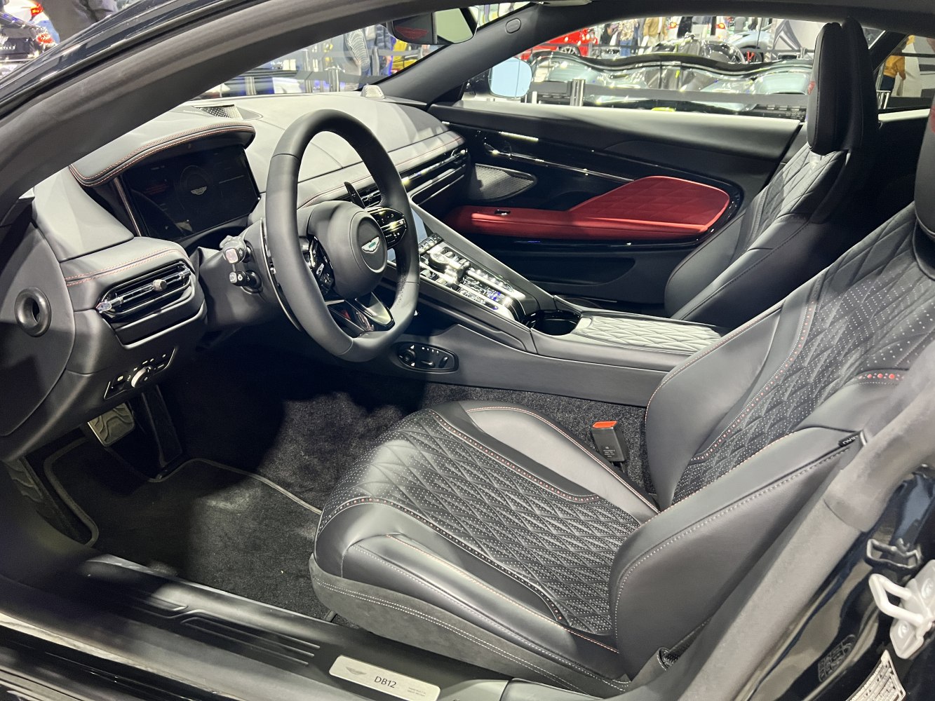 Luxury car interior with modern steering wheel and quilted leather seats