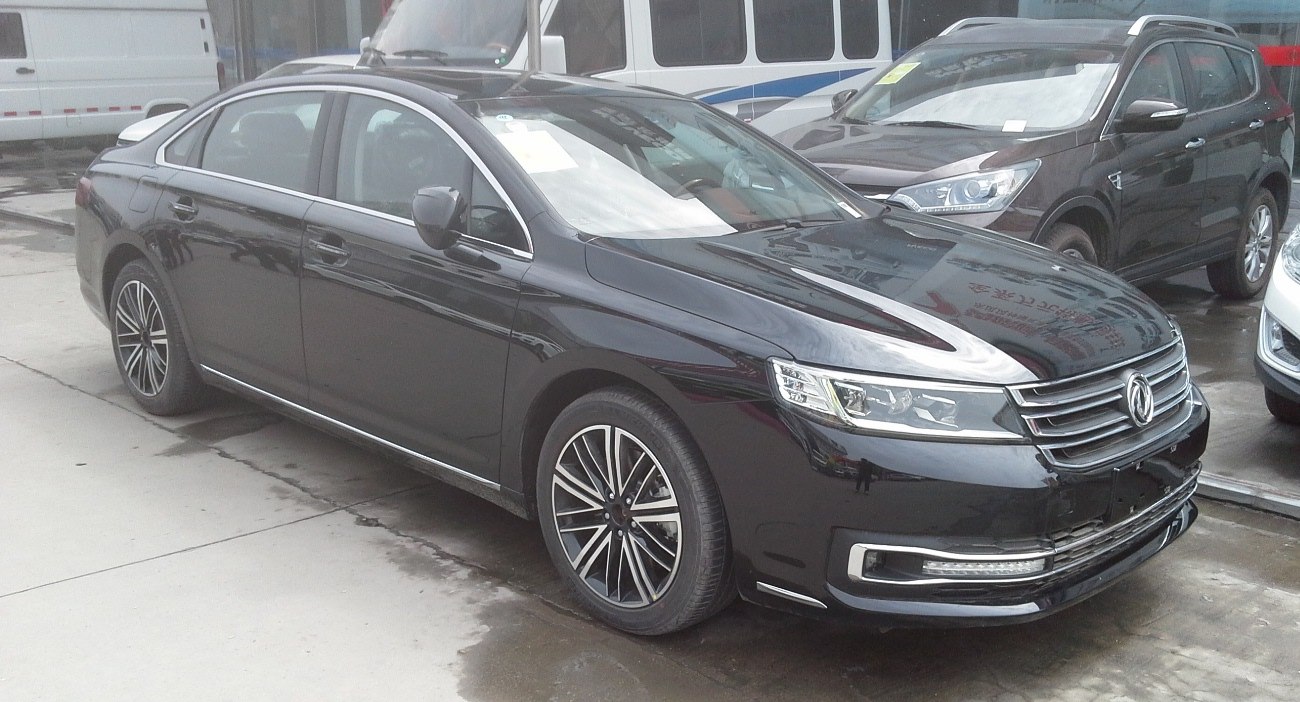 Front side view of a sedan with LED daytime running lights and alloy wheels