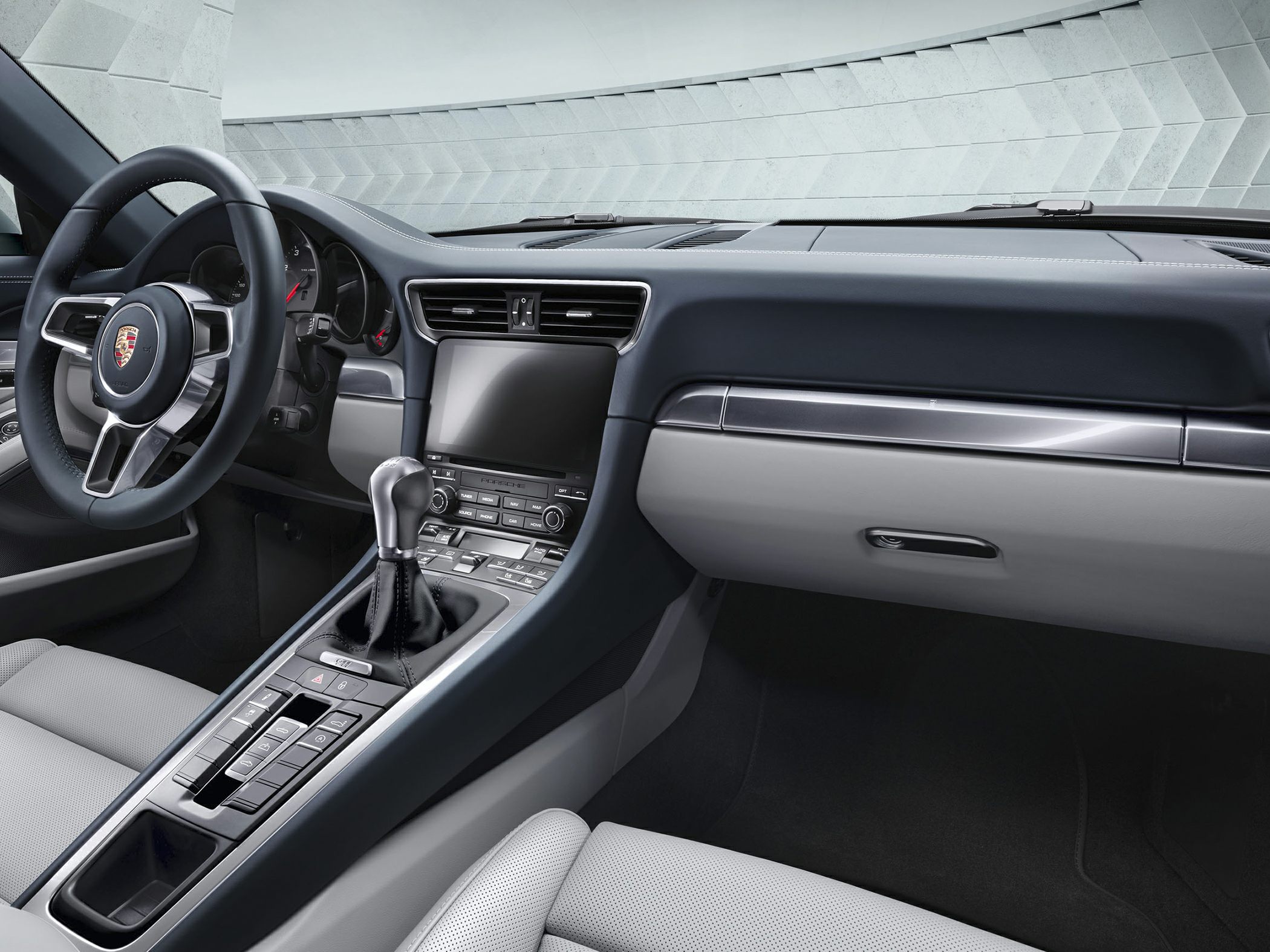 Dashboard, steering wheel, and manual gear shift in a sports car interior