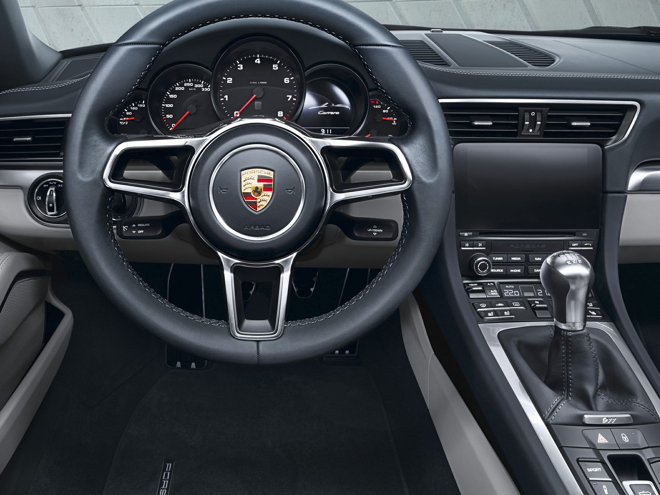 Close-up of a steering wheel and manual gear shifter in a luxury car interior