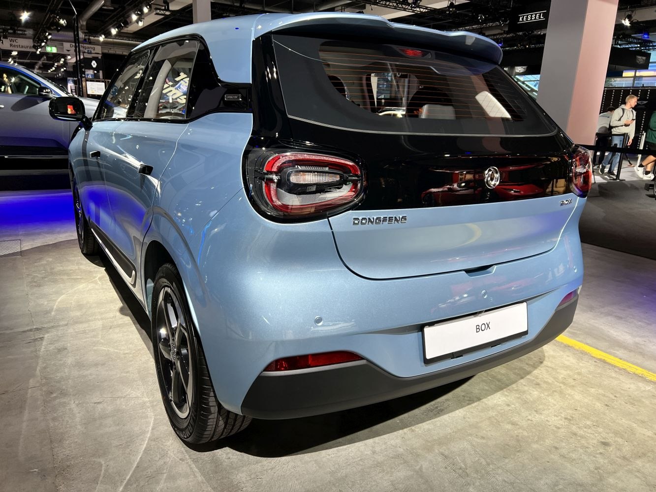 Rear view of compact electric vehicle with modern taillights and two-tone design