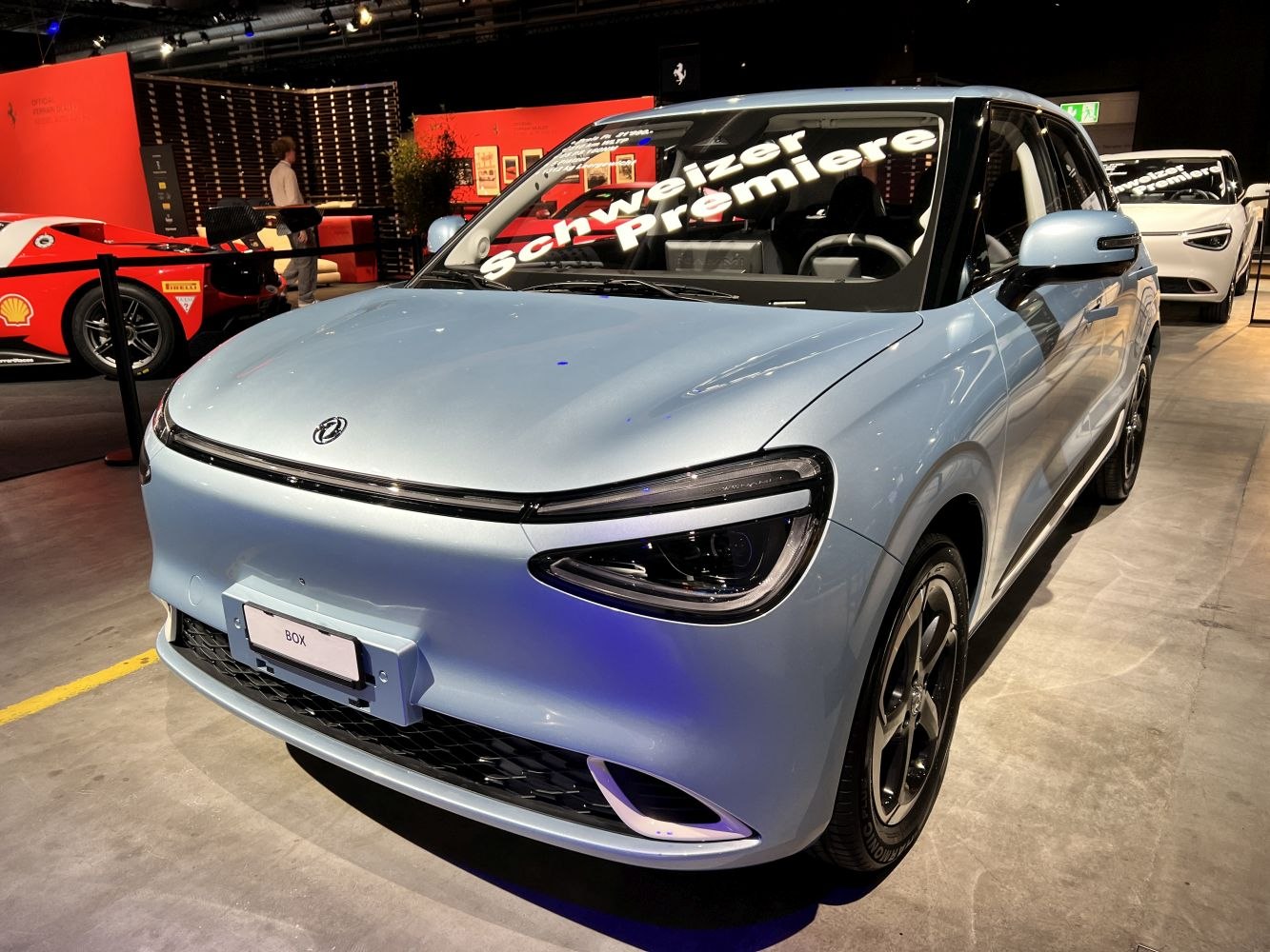Compact electric car with LED headlights and minimalist front grille