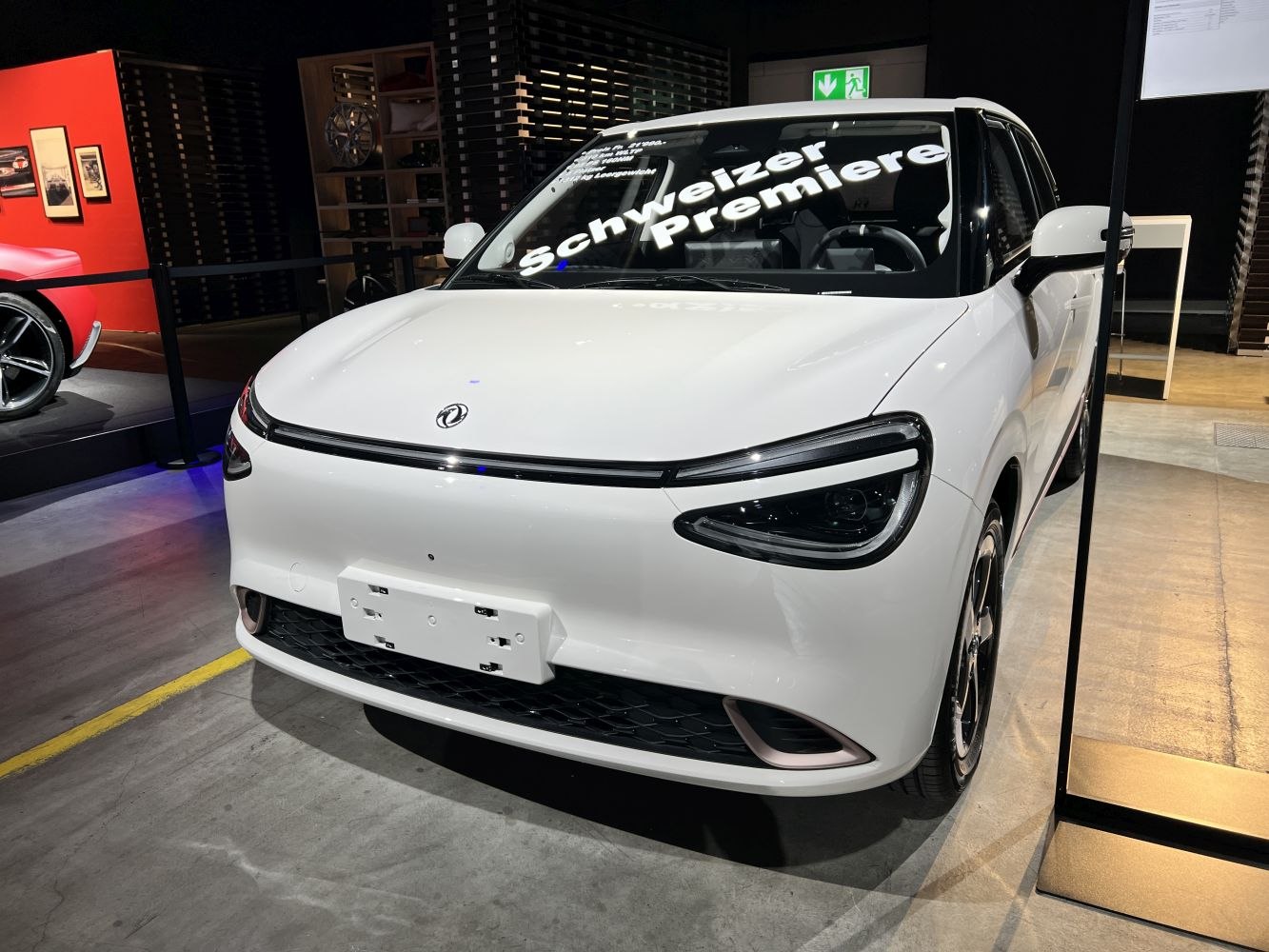 White compact electric vehicle front with sleek LED headlights