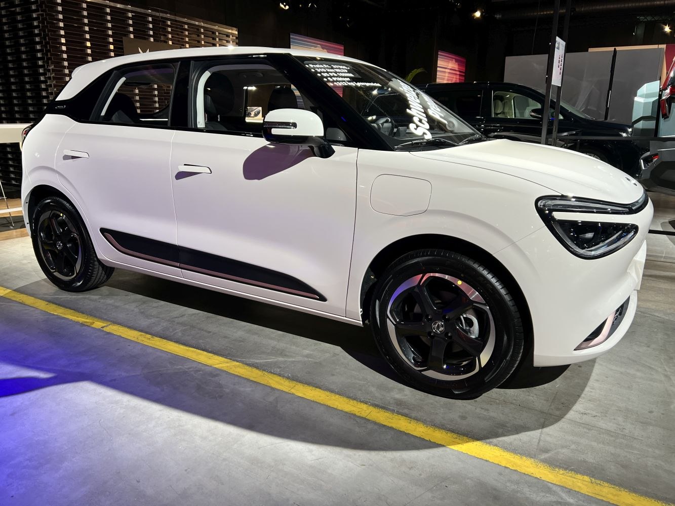White urban hatchback with distinctive headlights and black alloy wheels