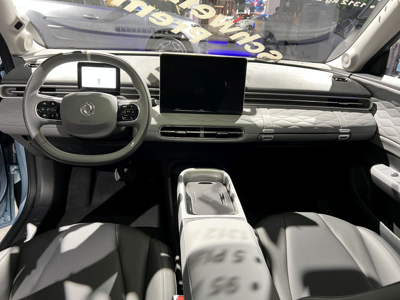 Modern car interior with large touchscreen and multifunction steering wheel