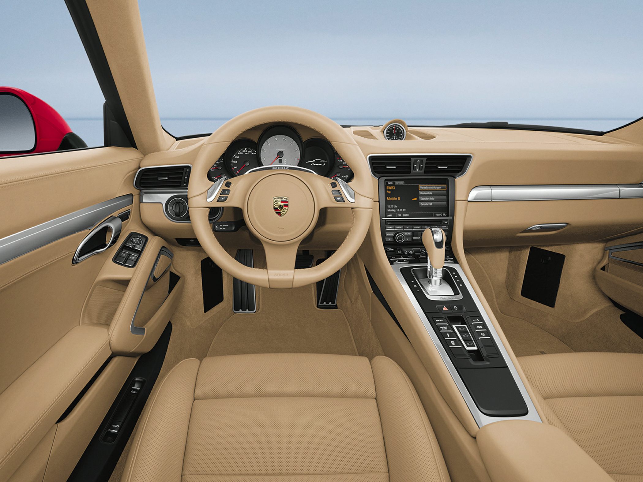 Beige car interior with dashboard, steering wheel, center console
