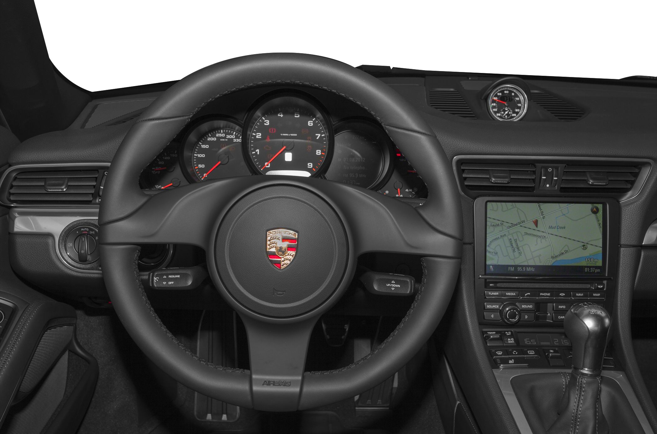 Steering wheel, dashboard gauges, analog clock, infotainment screen, manual gear shifter