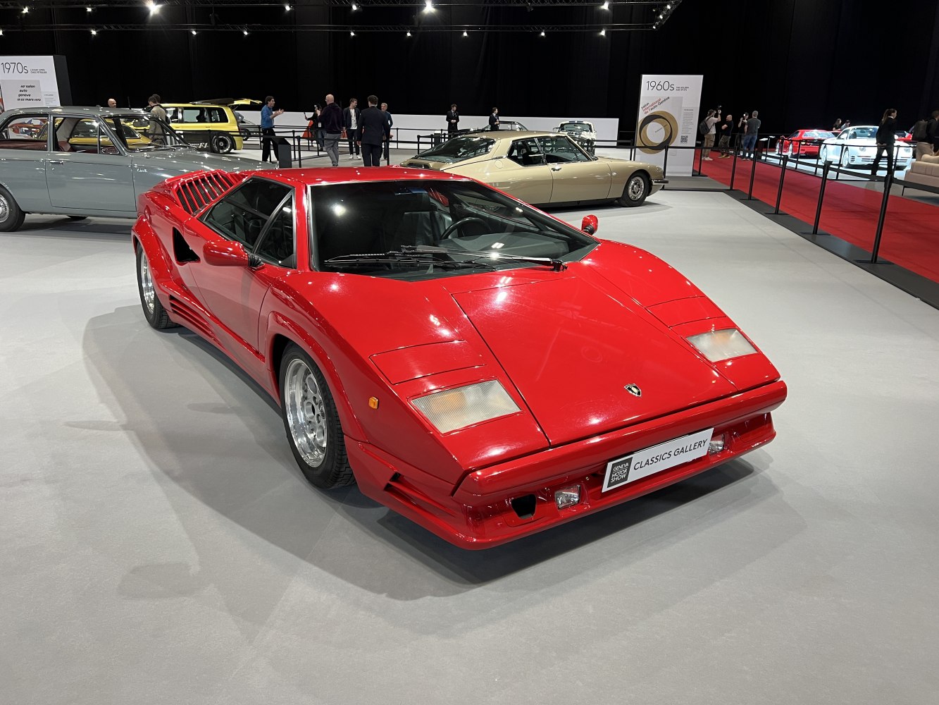 Red vintage supercar with angular body and pop-up headlights.