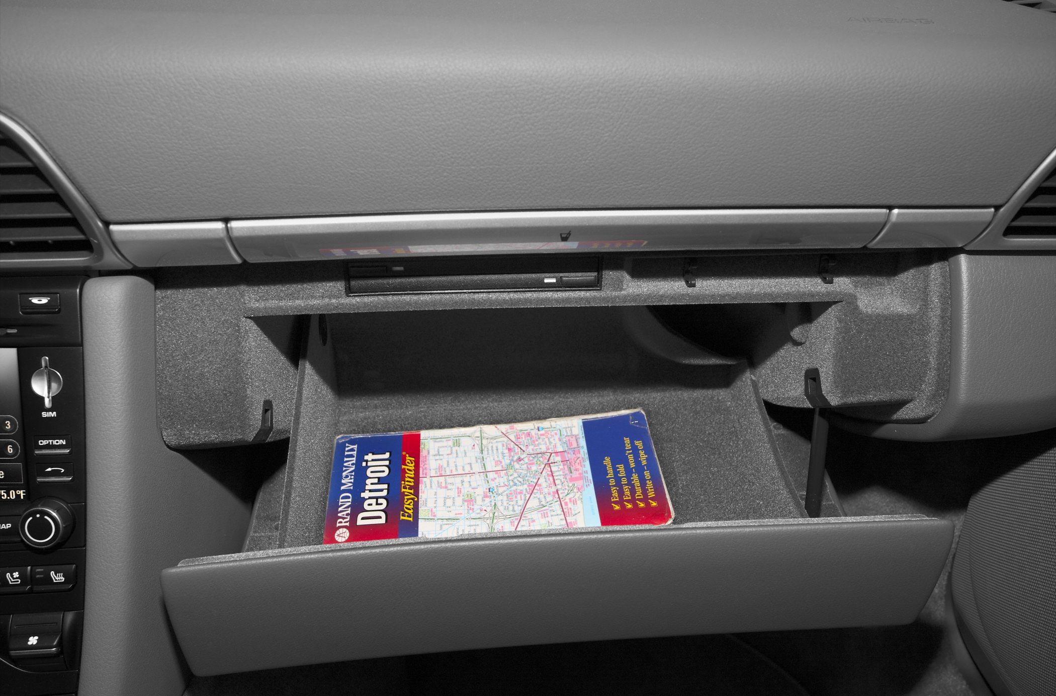 Open glove compartment with a navigation CD inside