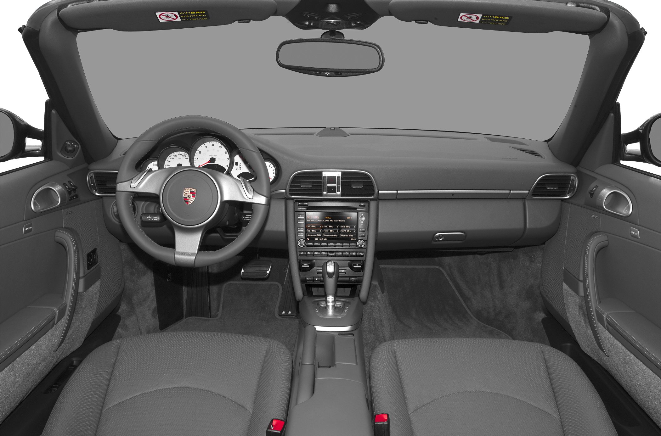 Dashboard and steering wheel layout with center console and instrument cluster.