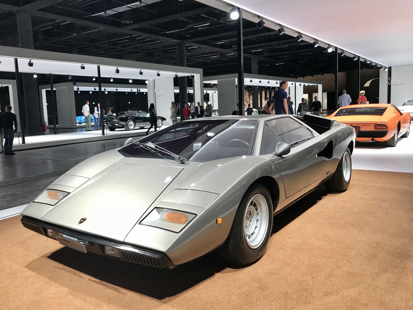 Silver Lamborghini Countach 1974 model front side with pop-up headlights and angular design