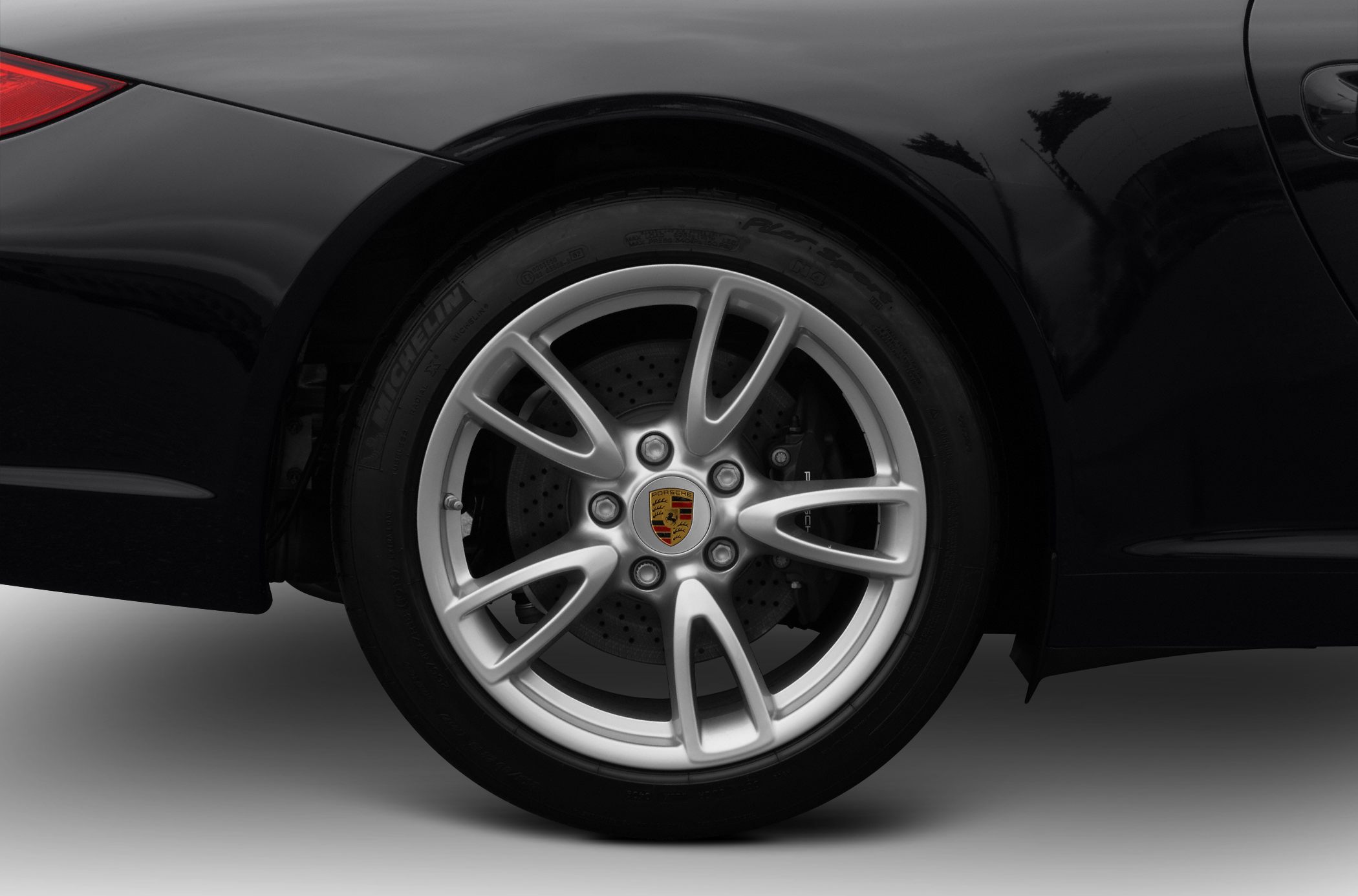 Silver 5-spoke alloy wheel with drilled brake disc and Michelin tire