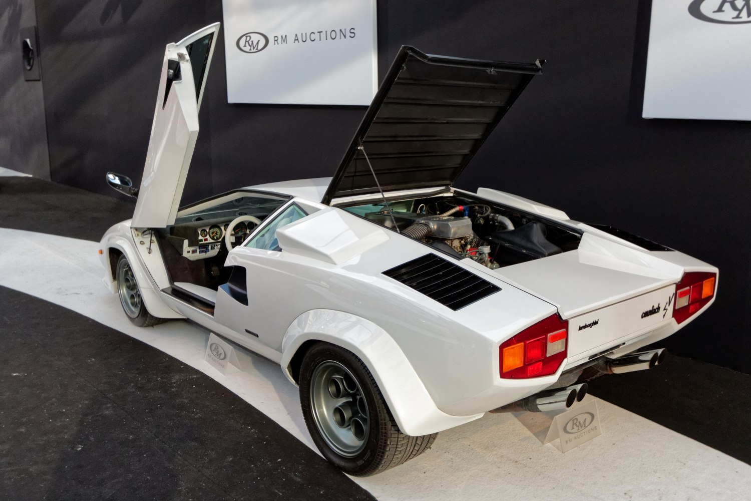 White Lamborghini Countach with rear engine open and scissor door