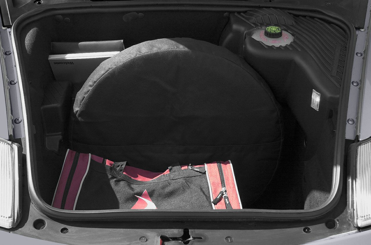 Front trunk storage with spare tire cover and luggage bag