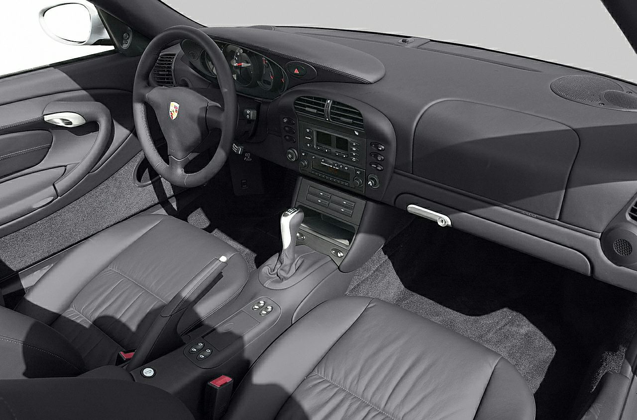 Leather seats, dashboard with manual gearshift, steering wheel.