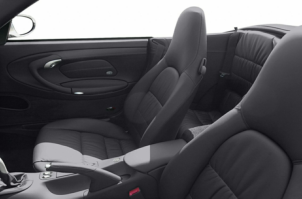 Leather front and rear seats with door panel and handbrake inside a car cabin