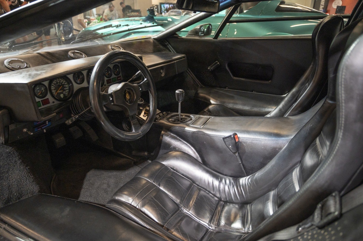 Vintage black leather seats and analog gauge dashboard interior