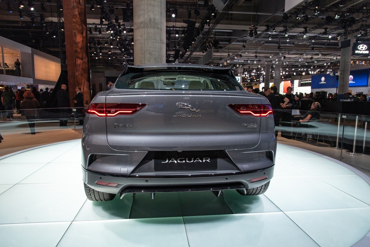 Rear view with distinctive tail lights and showroom display