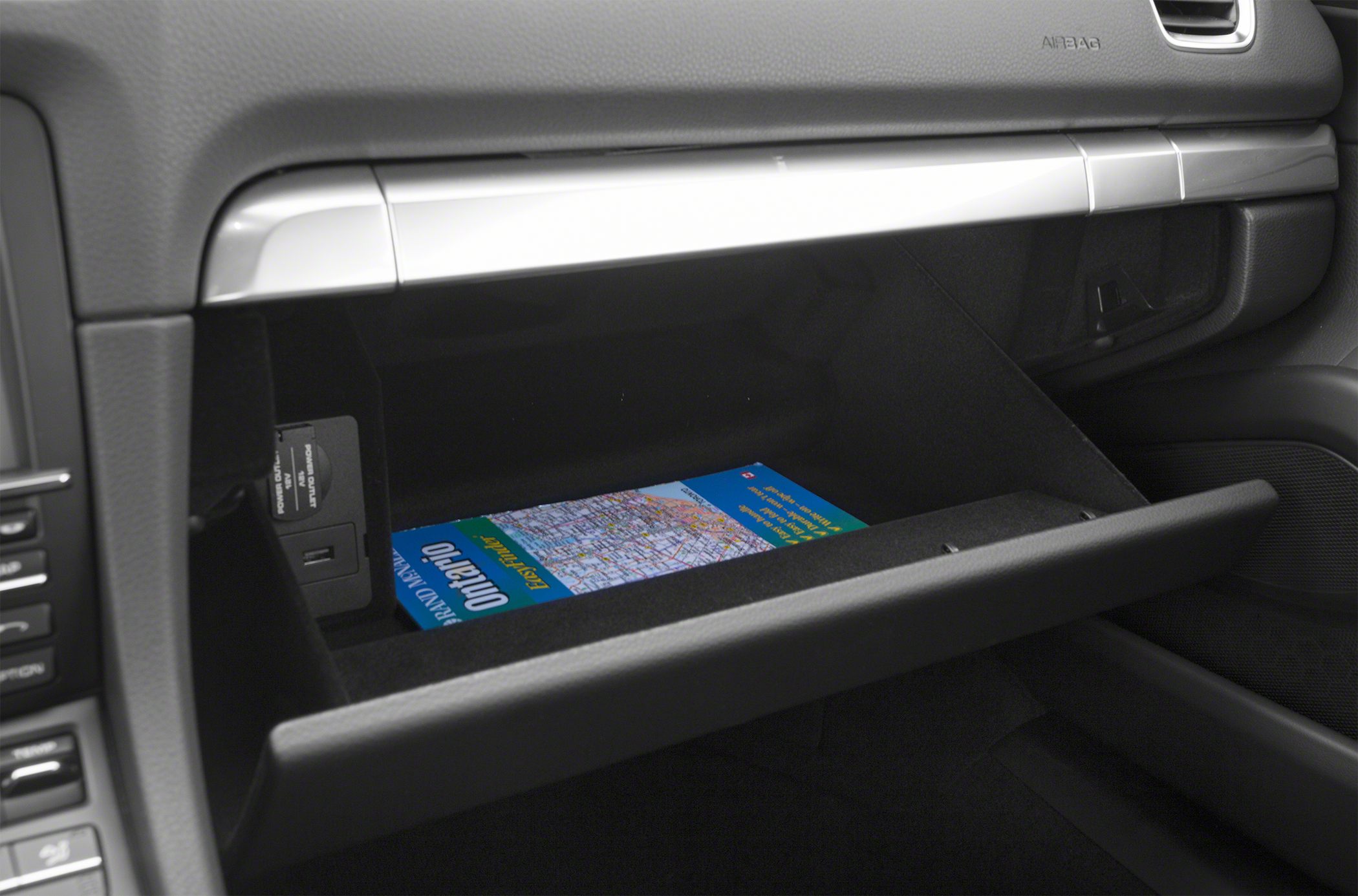 Open glove compartment with map inside