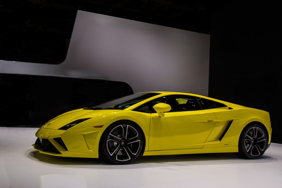 Side view of bright yellow sports car with aerodynamic shape and distinct air intakes
