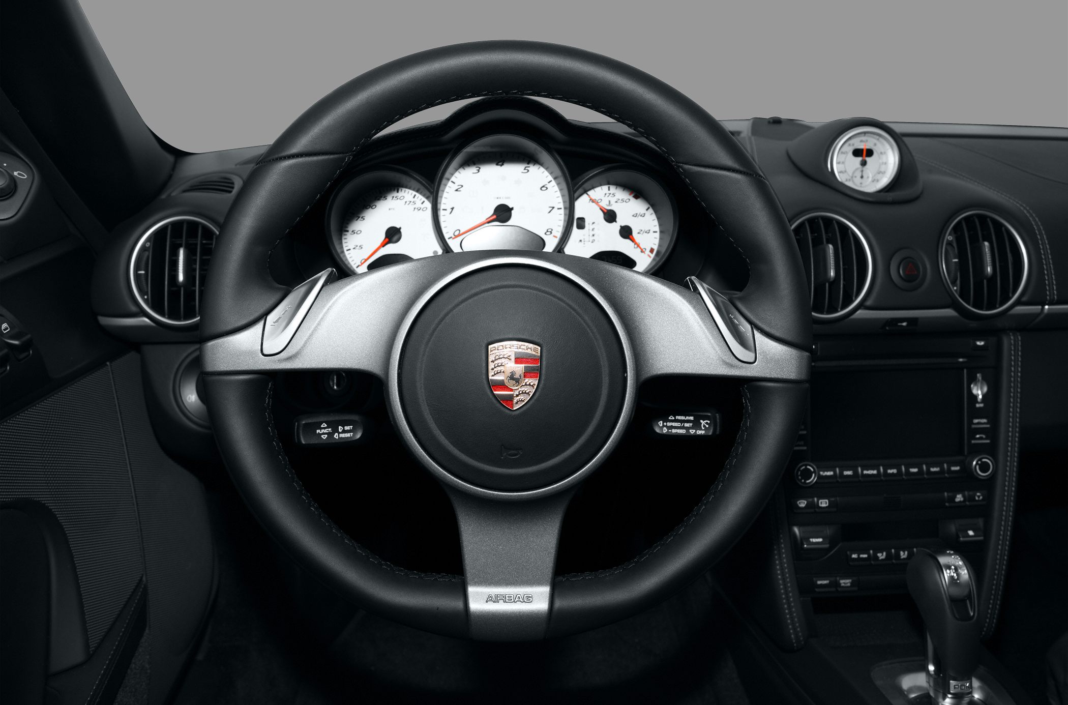 Steering wheel with paddle shifters and white instrument cluster dials