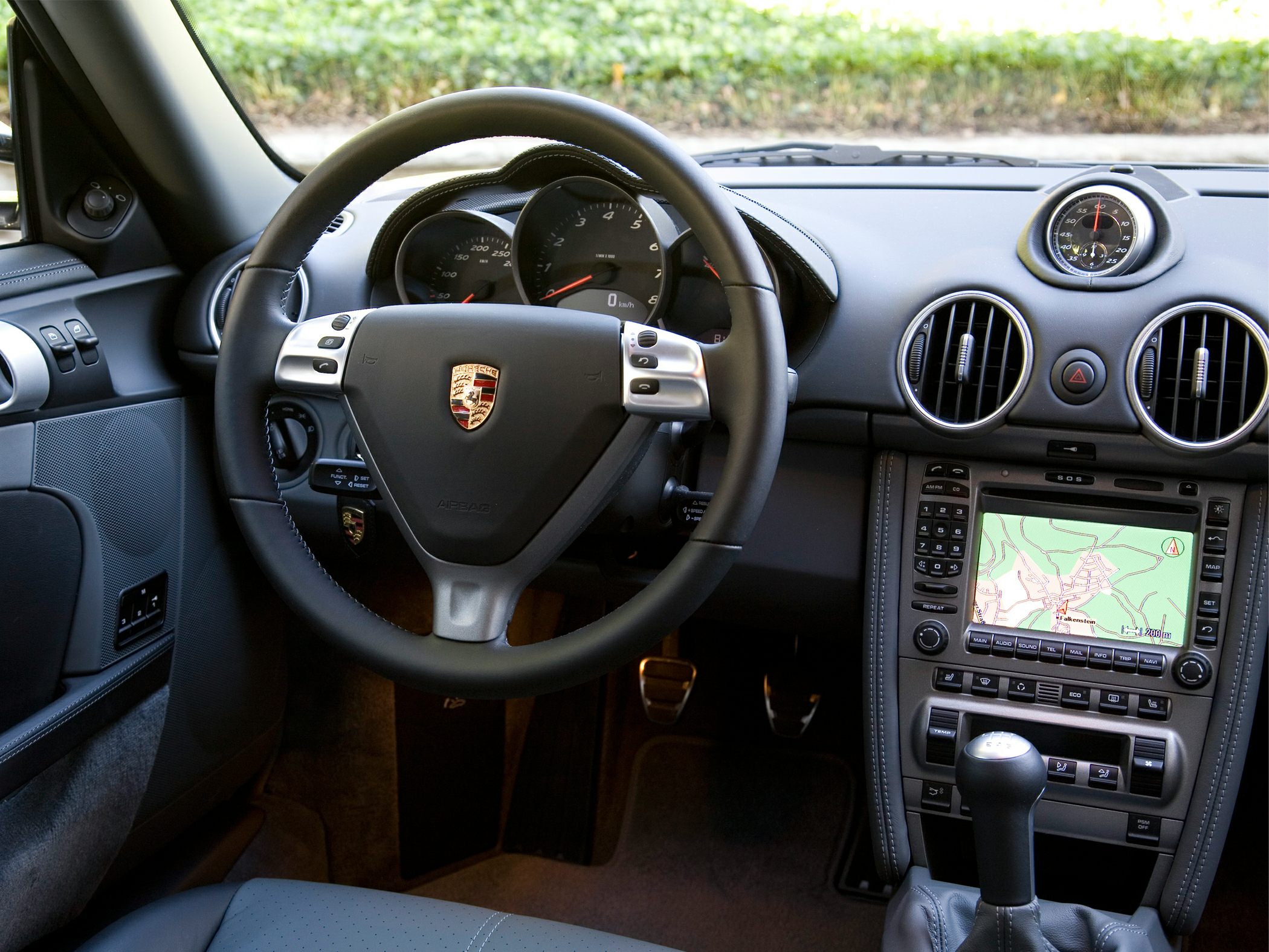 Dashboard and steering wheel with navigation system and analog clock