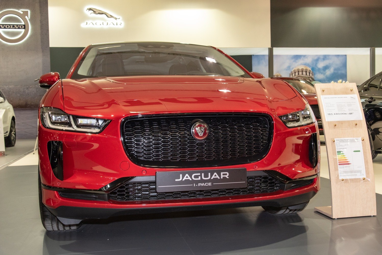 Front view of red SUV with signature grille and headlights
