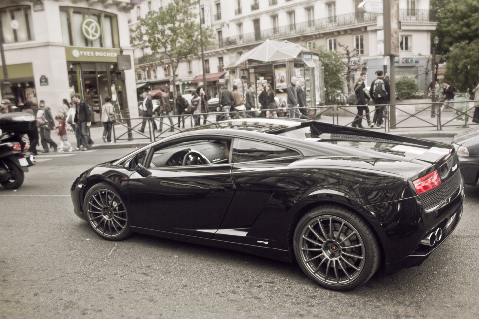 Black sports car with sleek side profile and distinctive rear design.