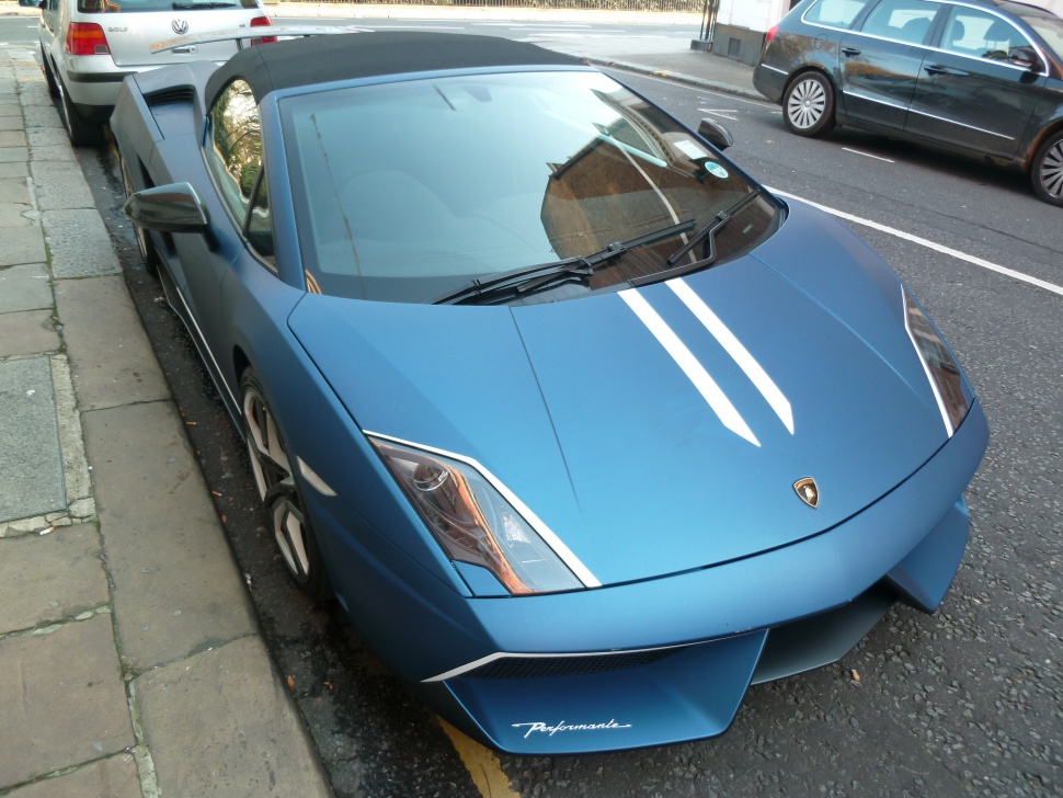 Matte blue front with sharp headlights and Performante badge