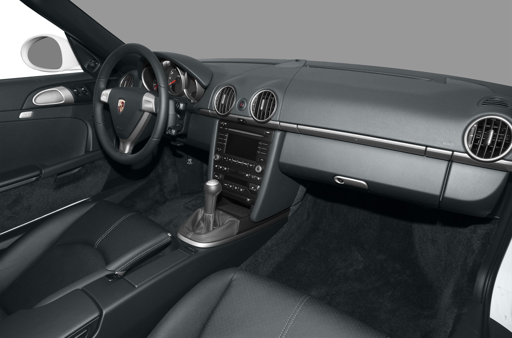 Manual transmission and black leather interior with round air vents