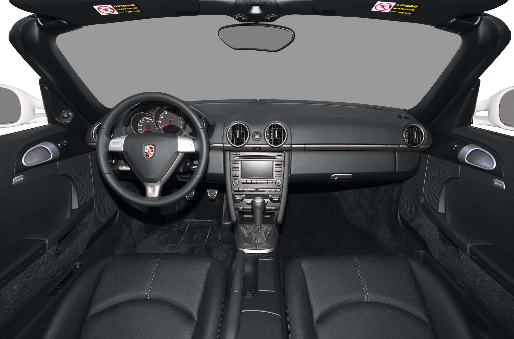 Dashboard, steering wheel, and interior cabin features of a convertible sports car