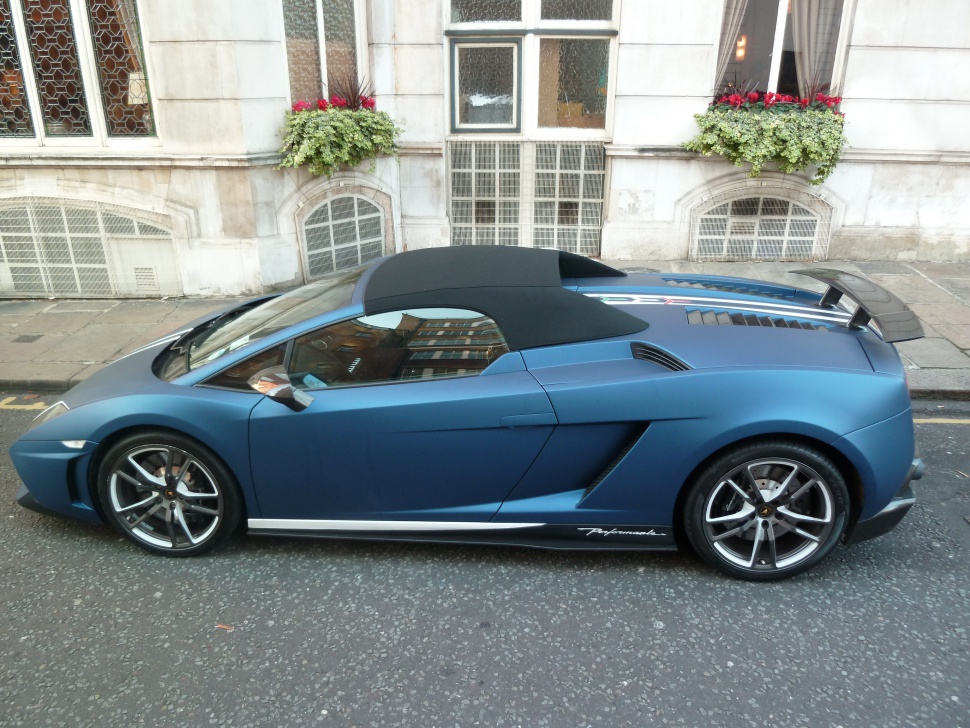 Side profile of a convertible sport coupe with aerodynamic features and soft top roof