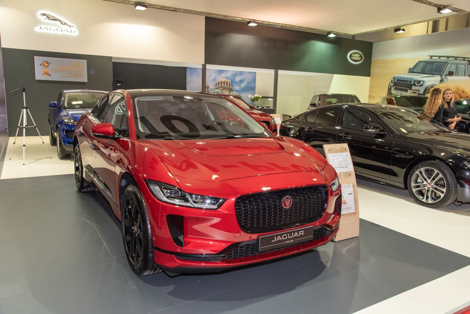 Front view of red electric SUV with sleek headlights and black grille.