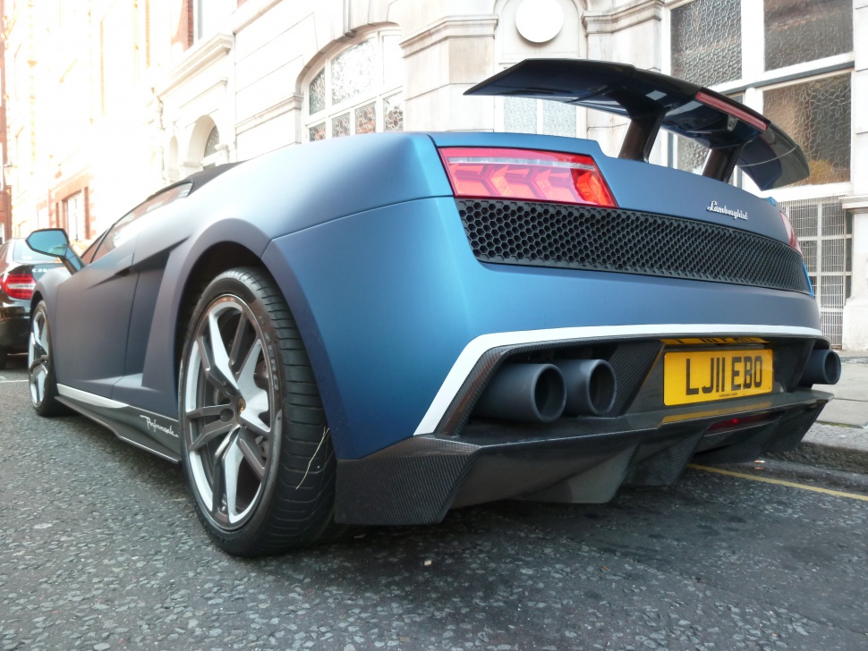 Rear view with exhaust, wheels, and rear wing details