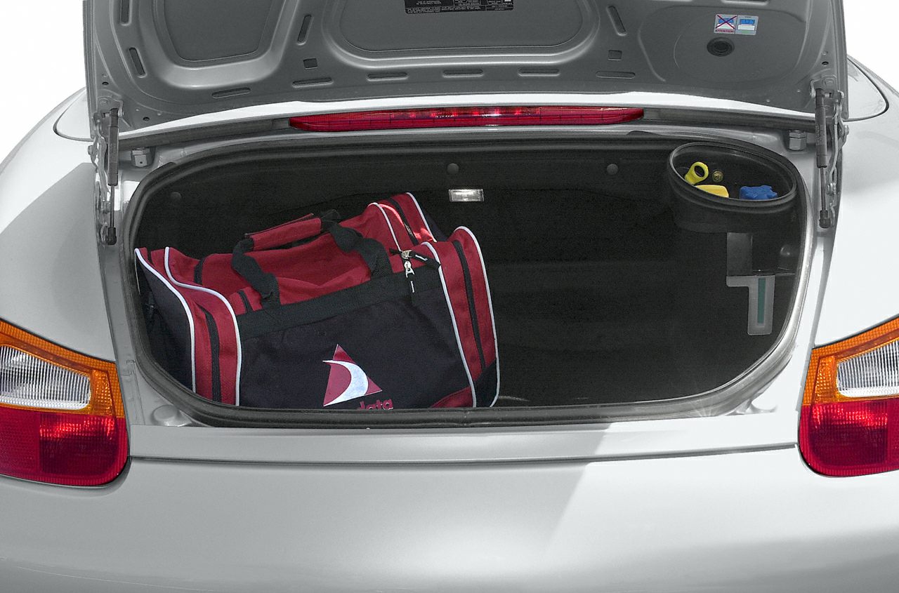 Open rear trunk space with a red bag inside and utility components visible.
