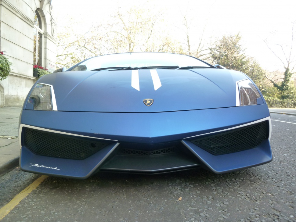 Front view with aggressive fascia, sharp headlights, and racing stripes