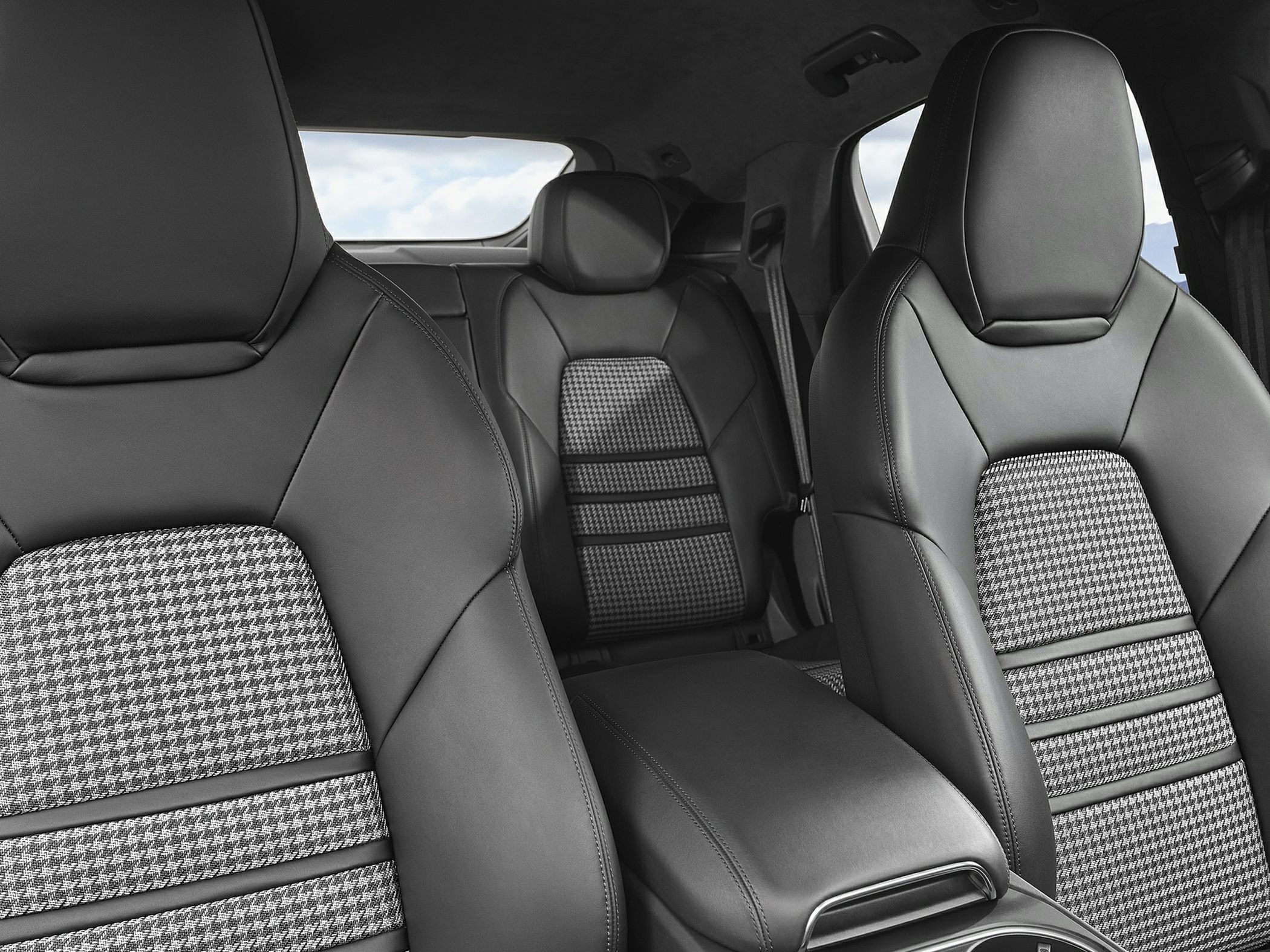 Leather and houndstooth patterned car seats with sporty design and rear seating.