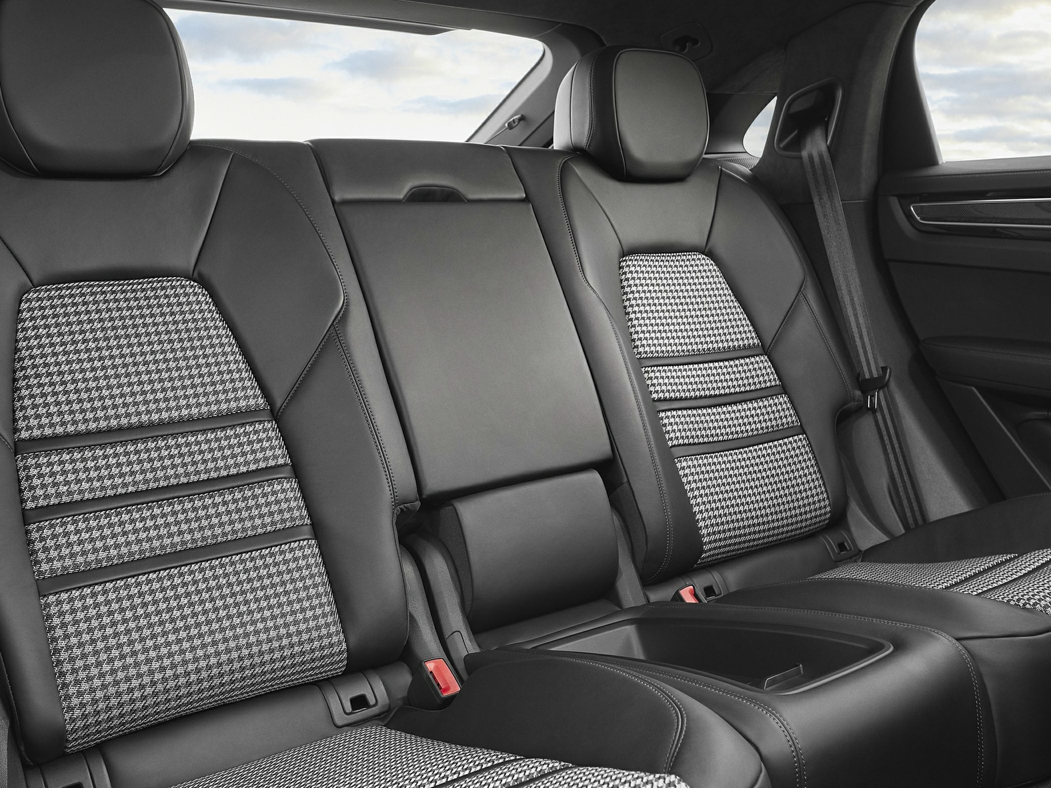 Premium leather rear seats with houndstooth fabric inserts and center armrest.