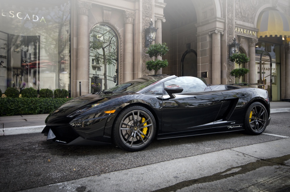 Sleek black convertible sports car with yellow brake calipers