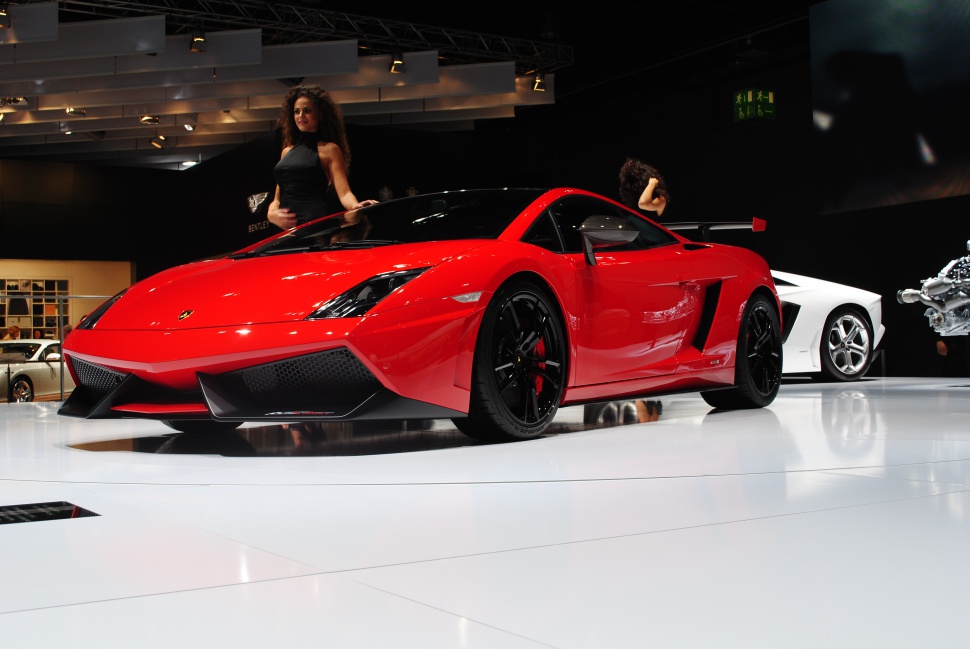 Aggressive front fascia and black alloy wheels of a red sports car