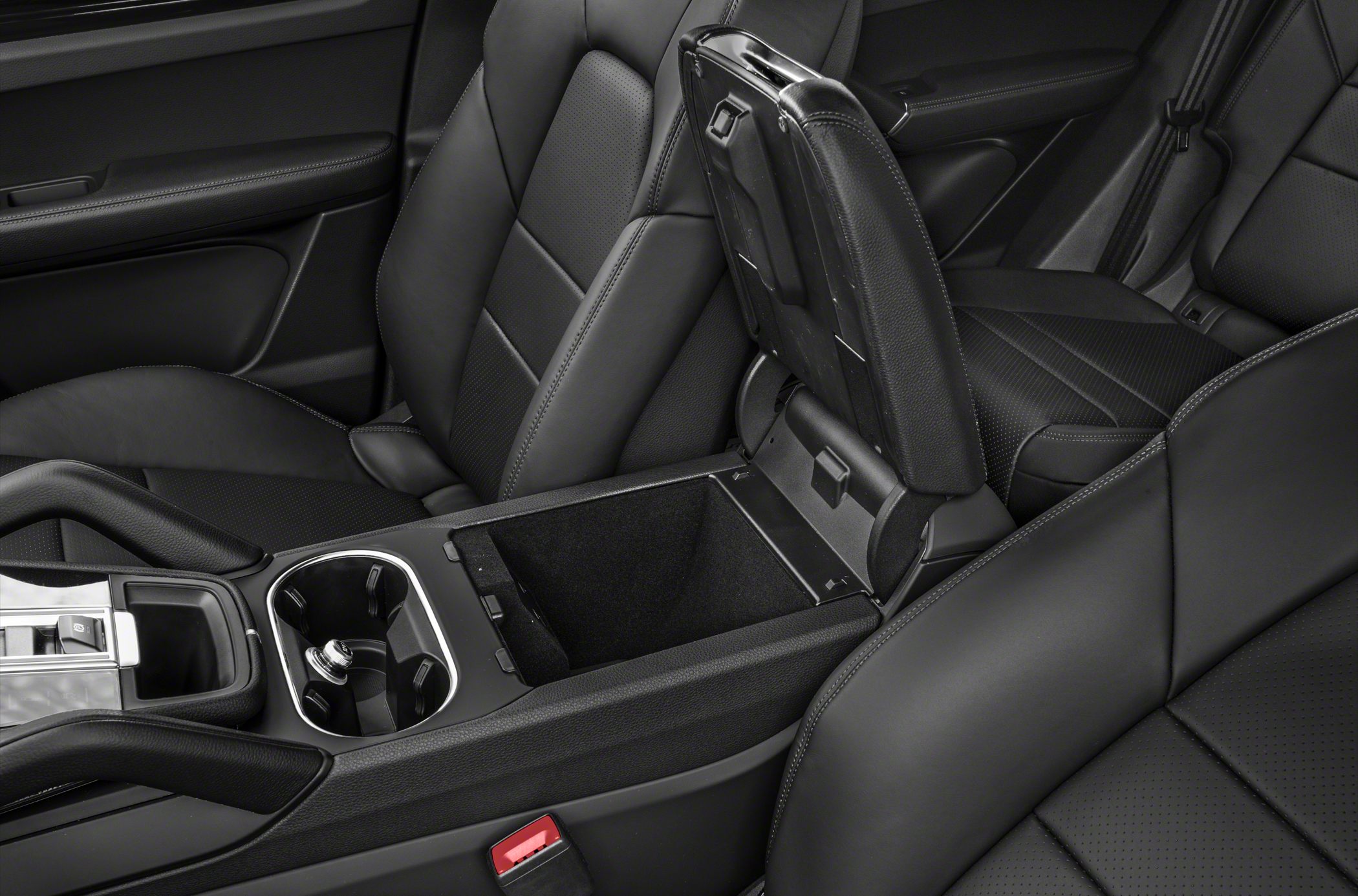 Open center console storage and cup holders in black leather interior