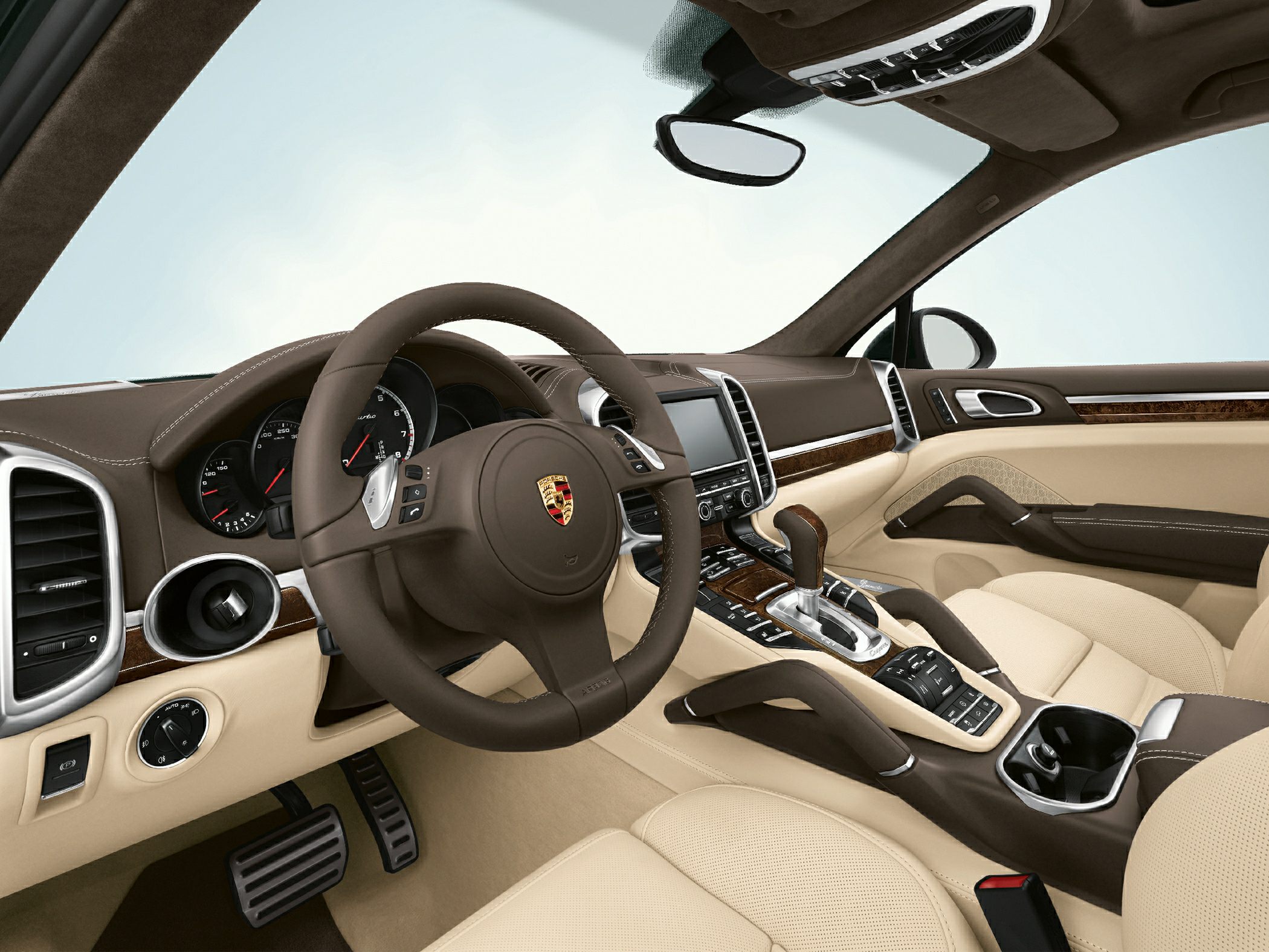 Luxury interior with dashboard and steering wheel featuring wood trim and beige leather