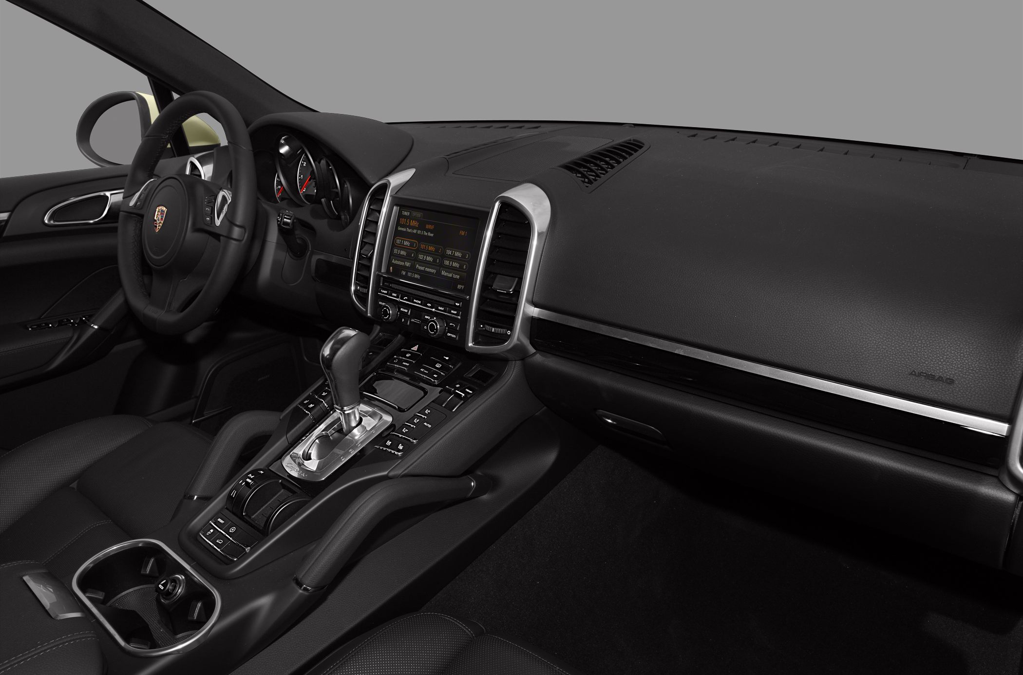 Black leather interior with steering wheel, digital display, and center console