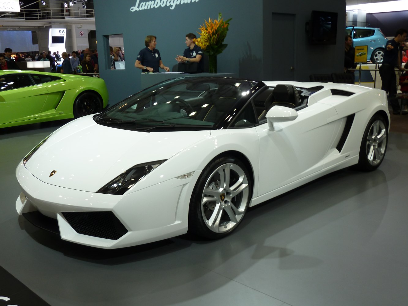White sleek convertible sports car with angular front design and open roof