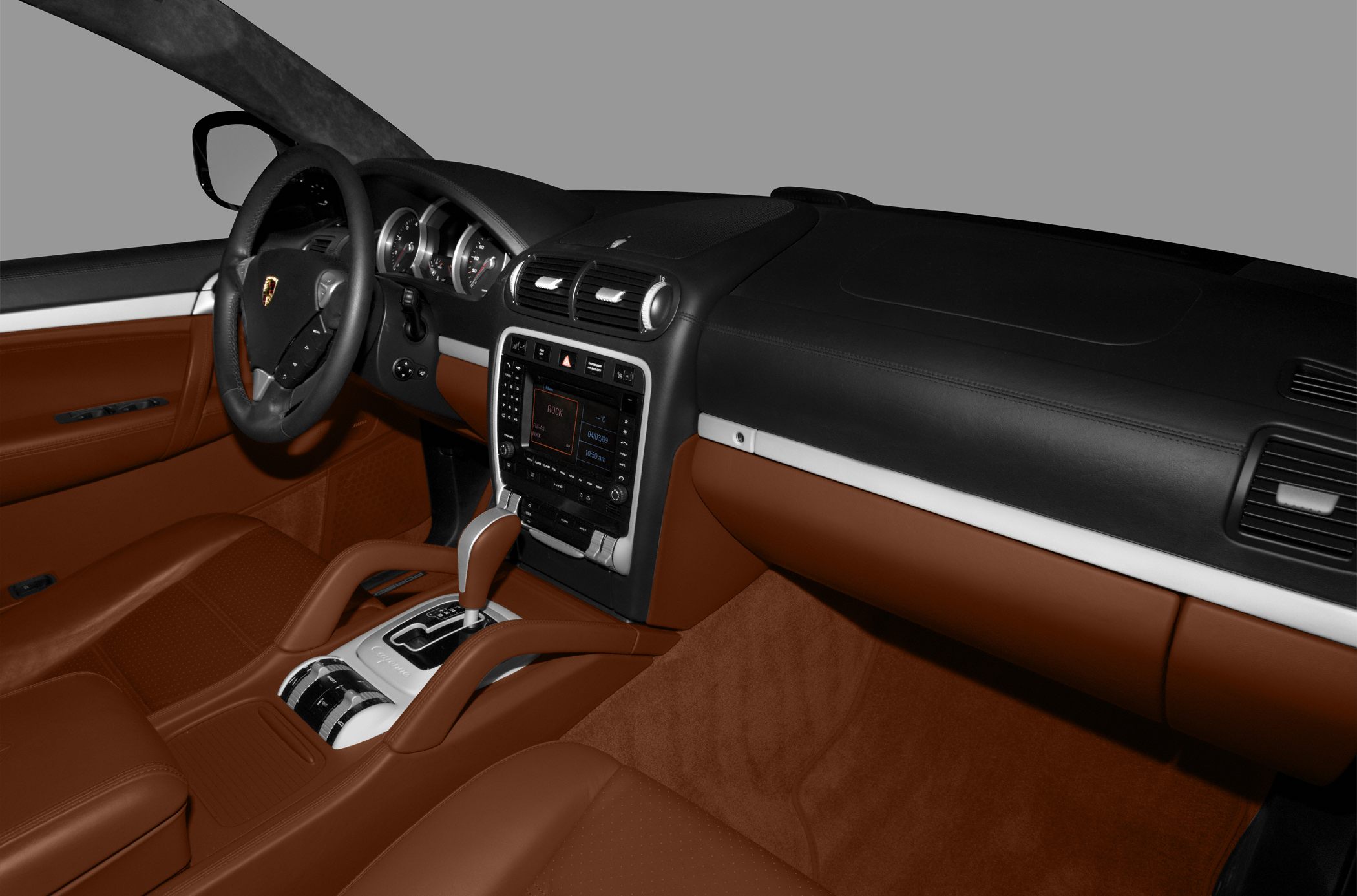 Brown leather seats and dashboard with center console and steering wheel