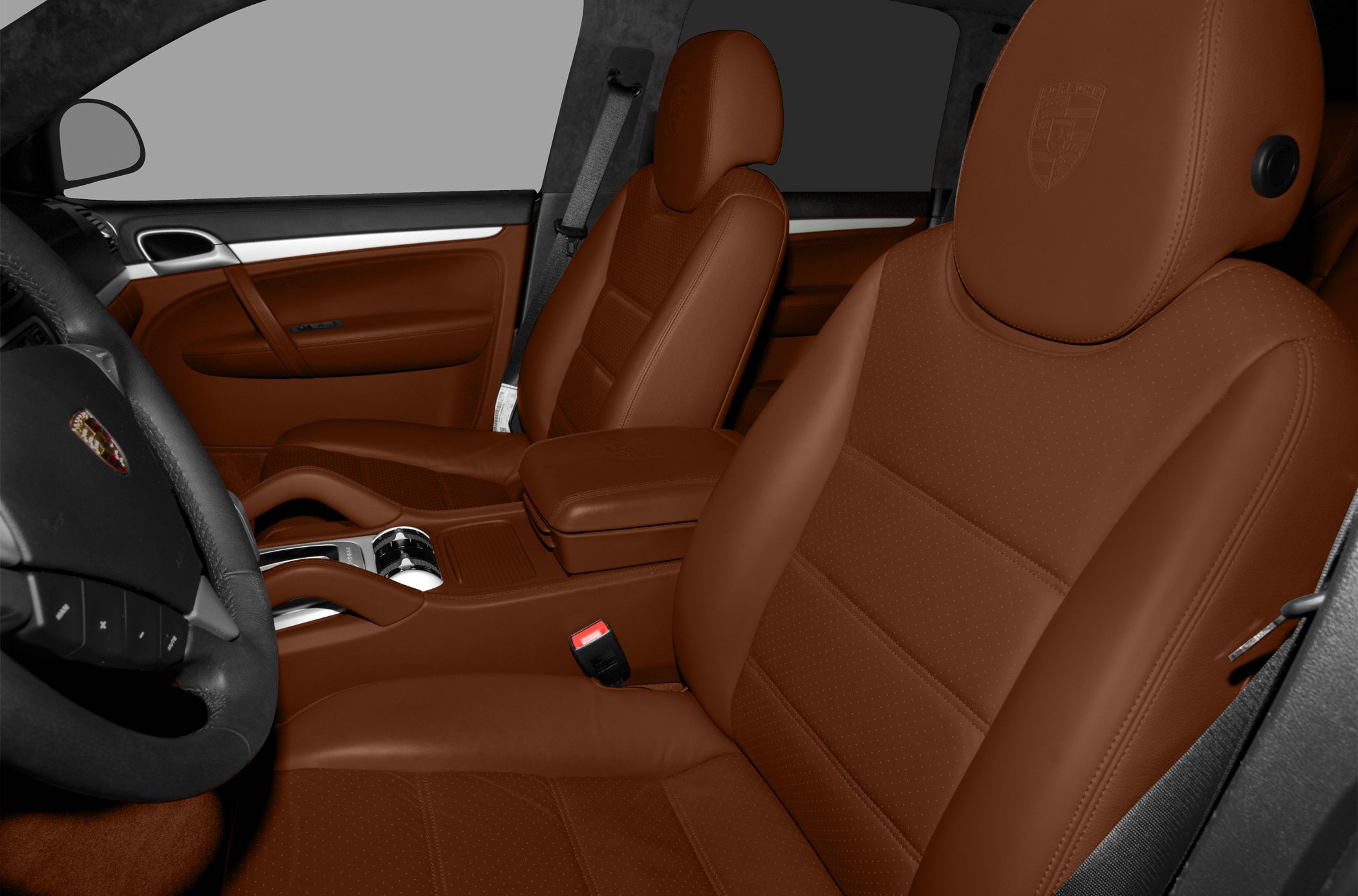 Brown leather front seats with embossed logos and center armrest