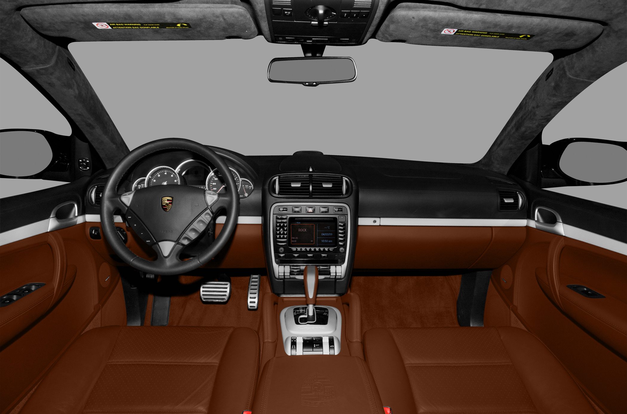 Steering wheel, multi-gauge cluster, center console with gear shifter and infotainment system.