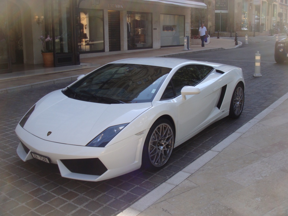 White Lamborghini with sharp front design and multi-spoke wheels