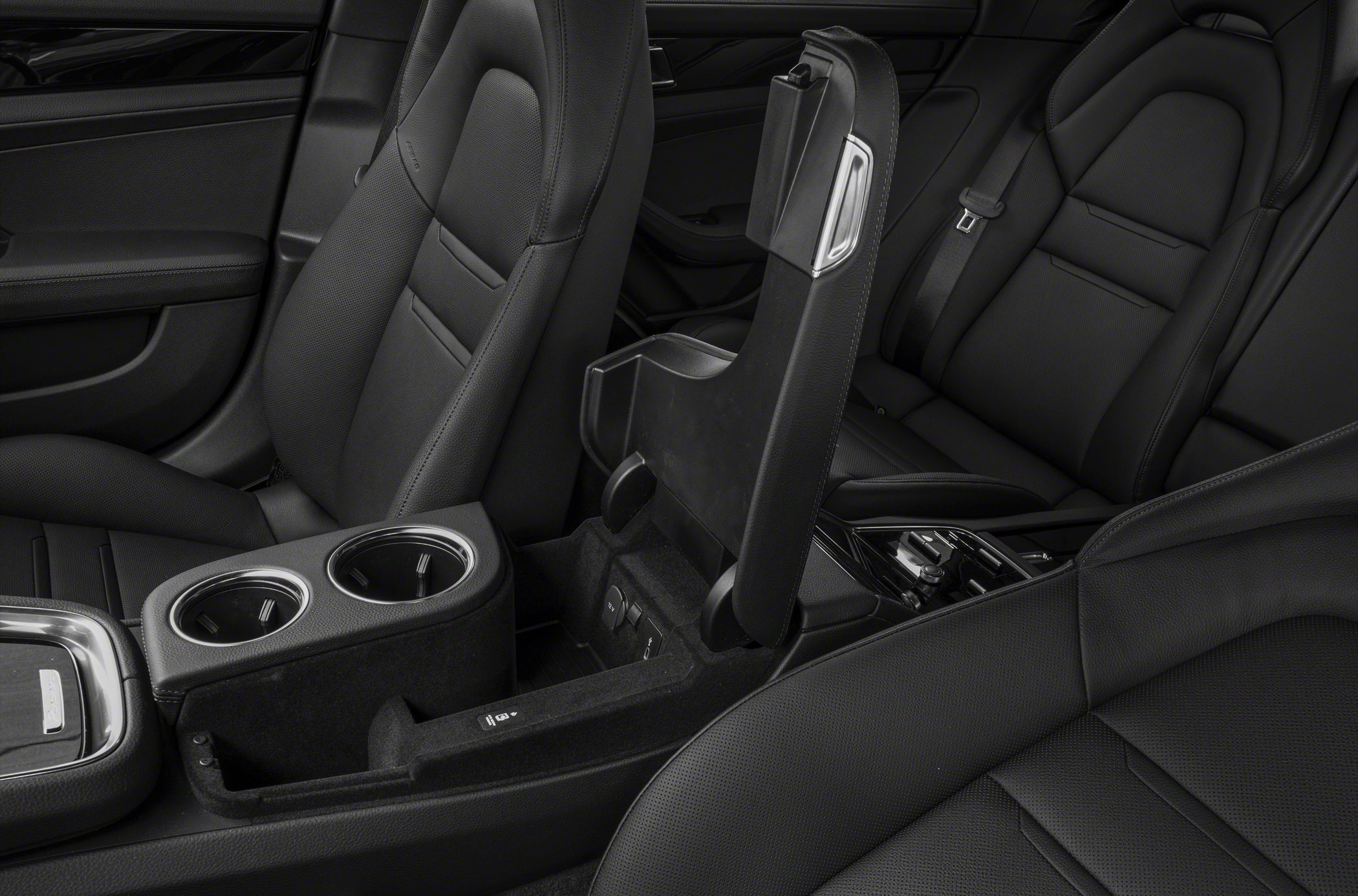 Black leather seats and open center console with cup holders and storage